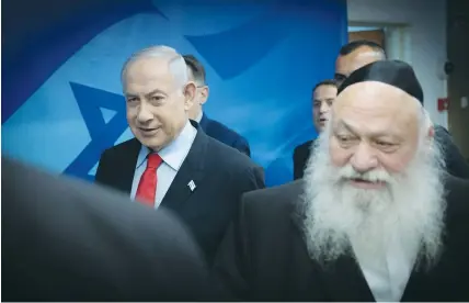  ?? (Chaim Goldberg/Flash90) ?? HOUSING MINISTER Yitzhak Goldknopf, leader of United Torah Judaism, arrives for a cabinet meeting together with Prime Minister Benjamin Netanyahu.