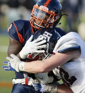  ?? PAUL CONNORS / BOSTON HERALD ?? HOLDING ON TIGHT: Milton Academy’s Jonathan (left) hangs onto the ball while take a hit from Belmont Hill’s Grant Litchfield in the second quarter of Saturday’s game.