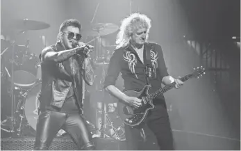  ?? PHILLIP CHIN, WIREIMAGE ?? Adam Lambert, left, and Brian May of Queen perform with a reverence to the band’s past.