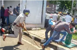  ?? — PTI ?? Police personnel baton- charge on youth during a protest demanding permanent jobs in the state government service in front of Madhya Pradesh chief minister Shivraj Singh Chouhan’s residence in Bhopal on Friday.
