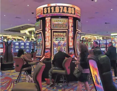  ?? ?? Slot machines at the Hard Rock casino in Atlantic City, N.J., are busy on Aug. 8, 2022. Figures released on Wednesday by the American Gaming Associatio­n show the U.S. commercial casino industry won over $60 billion from gamblers in 2022.