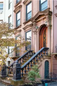  ??  ?? BELOW The brownstone façade is in good condition. As is often the case, however, steps to the main entry had to be completely redone. OPPOSITE An extremely light, airy chandelier by Moooi acts as a foil for dense, ornate plaster decoration in the dining room.