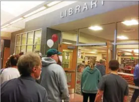  ?? EVAN BRANDT — DIGITAL FIRST MEDIA ?? Residents taking Friday’s tour of the renovated high school stop by the school’s new library.