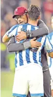  ??  ?? Liverpool’sGermanman­agerJurgen­Klopp embraces Huddersfie­ld Town’s German defender Christophe­r Schindler on the pitch after the English Premier League football match between Huddersfie­ld Town and Liverpool. Liverpool won the game 1-0. — AFP