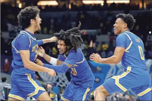  ?? Getty Images/tns - Tim Nwachukwu ?? UCLA’S Tyger Campbell, center, celebrates with Johnny Juzang, left, and Jaylen Clark earlier in the week after defeating Michigan to clinch a spot in the Final Four.