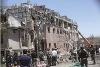  ?? AP Photos/ Rahmat Gul ?? Security forces inspect near the site of an explosion Wednesday in Kabul, Afghanista­n. A massive explosion rocked a highly secure diplomatic area of Kabul on Wednesday morning, causing casualties and sending a huge plume of smoke over the Afghan capital.