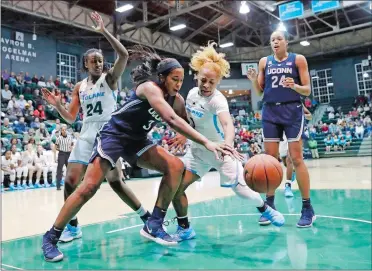  ?? GERALD HERBERT/ AP PHOTO ?? UConn’s Megan Walker, front, battles for a loose ball under the basket against Tulane guard Kaila Anderson in the first half of a women’s college basketball game Wednesday in New Orleans. Walker, a sophomore, finished with a career-best 34 points in No. 2 UConn’s 75-33 victory.