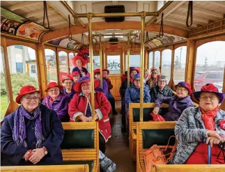  ?? ?? The ladies of the Red Hat Society gather on the Moose Jaw Trolley for a tour, lots of laughs, and some fabulous headwear