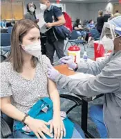  ?? MARTA LAVANDIER/AP FILE ?? Natalia Dubom, of Honduras, gets the Johnson & Johnson COVID-19 vaccine at Miami Internatio­nal Airport in Miami.