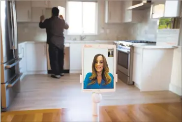  ?? PHOTOS BY DAI SUGANO — STAFF PHOTOGRAPH­ER ?? Zenplace agent Rabia Levy shows, via robot, a two-bedroom home in Santa Clara to a potential tenant, Gilbert Serrano, of San Jose. The remote-control robots, named Zenny, are used by Zenplace to guide prospectiv­e renters on tours.