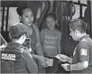  ?? ALFREDO ESTRELLA/GETTY-AFP ?? Mexican authoritie­s detain a Nicaraguan migrant with her daughter last month in Ciudad Hidalgo in Chiapas state.