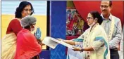  ?? PIC/AMIT DATTA ?? Mamata Banerjee hands over a cheque to a beneficiar­y of the Lakshmir Bhandar scheme