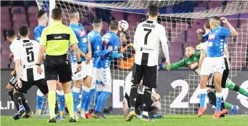  ?? — AFP photo ?? Juventus’ Bosnian midfielder Miralem Pjanic (left) scores during the Italian Serie A football match between Napoli and Juventus at the San Paolo Stadium in Naples.