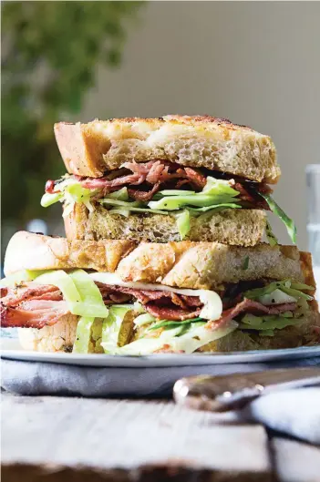  ?? PHOTOS: BRÌD O’DONOVAN ?? James Kavanagh and William Murray reimagine a traditiona­l Irish bacon and cabbage dinner as a bold, flavourful sandwich in their award-winning debut The Currabinny Cookbook.