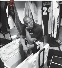  ??  ?? COOLING OFF: Kobe Bryant sits in front of his locker at Madison Square Garden in New York.