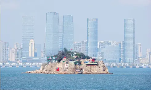  ?? REUTERS ?? The Taiwanese flag is seen painted on Shihyu Islet in front of the coastal Chinese city of Xiamen last year. It is part of a group of islands that make up the Taiwanese county of Kinmen, the last place where China and Taiwan engaged in major fighting in 1958 at the height of the Cold War.