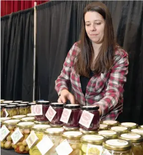  ?? CITIZEN PHOTO BY BRENT BRAATEN ?? Amanda Theberge from Thelma’s Goodies puts out a selection of pickled specialtie­s in her booth at Studio Fair in the Civic Centre. The 41st edition of Studio Fair opens Friday morning at 10 a.m.
