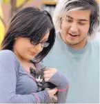  ??  ?? Samantha Thompson holds the kitten that she and her boyfriend, Gene Chavez, rescued from a storm drain Wednesday.