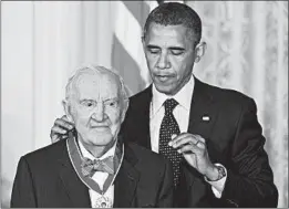  ?? MANDEL NGAN/GETTY-AFP ?? Retired Supreme Court Justice John Paul Stevens receives the Presidenti­al Medal of Freedom from President Barack Obama in 2012 at the White House. Stevens died Tuesday.