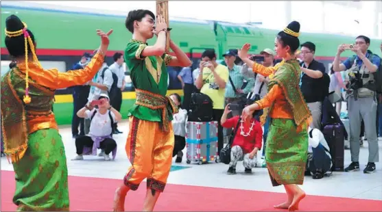  ?? ?? Local dancers perform in Vientiane, capital of Laos, on April 13 to welcome internatio­nal passengers who rode the China-Laos Railway.