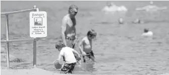  ??  ?? A sign warns bathers about a sudden drop-off at Thetis Lake. A report by Capital Regional District parks staff advocates more signs and education, but not reinstatin­g lifeguards, at the lake.