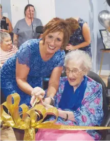  ??  ?? Glen Haven Manor CEO Lisa Smith cuts the ribbon with Clara Teed to mark the grand opening of Clara’s Place.