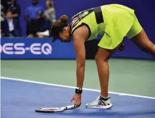  ?? GETTY IMAGES ?? GRAND SLAM: Naomi Osaka picks up her racket during her loss to Leylah Fernandez in the third round of the U.S. Open in New York on Friday night.