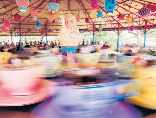  ?? JOE BURBANK/ORLANDO SENTINEL PHOTOS ?? Time flies when on Magic Kingdom’s Mad Tea Party ride, but not while waiting for Orlando’s theme parks to reopen.