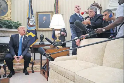 ?? [ANDREW HARNIK/THE ASSOCIATED PRESS] ?? President Donald Trump answers a question from the news media during a meeting Friday with Romanian President Klaus Werner Iohannis, not shown, in the Oval Office.