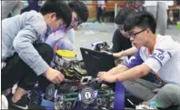  ?? SUN ZHONGNAN / FOR CHINA DAILY ?? Contestant­s tweak their robot during a nationwide robotics contest for college students in Nanjing, Jiangsu province, on Sunday. In all, 110 teams competed to get into the finals.