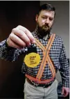  ?? TY GREENLEES / STAFF ?? A blinking safety light and reflective belts are modeled by Miami Valley Regional Planning Commission’s Paul Arnold.