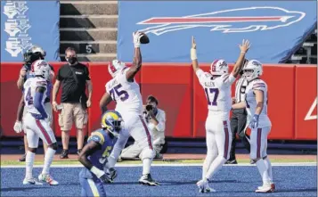  ?? Bryan M. Bennett / Getty Images ?? The Bills celebrate after scoring a touchdown during the second quarter against the Rams at Bills Stadium on Sunday in Orchard Park. Buffalo improved to 3-0.