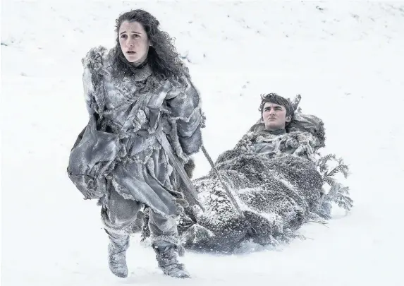  ?? HELEN SLOAN / HBO ?? > Isaac Hempstead Wright, as Bran Stark, with Ellie Kendrick as Meera Reed in Game of Thrones