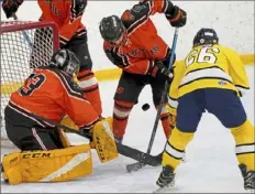  ?? Matt Freed/Post-Gazette ?? Bethel Park's Jadon Tietz, middle, and his first-line teammates will be looking to neutralize the action in front of goaltender Zack Ott in the PIHL playoffs.