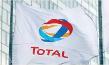  ?? — Reuters ?? The logo of French oil giant Total is seen on a flag at La Defense business and financial district in Courbevoie near Paris, France.