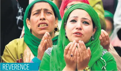  ?? Picture: AFP ?? Kashmiri Muslims pray as a custodian displays a holy relic, believed to be a hair from the Prophet Muhammad’s beard, during celebratio­ns for Miraj-Ul-Alam at Kashmir’s Hazratbal Shrine in Srinagar yesterday.