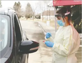  ?? JIM WELLS ?? Dr. Amelia Leskiw takes COVID-19 samples at a drive-thru location in High River recently. The town is planning a big thank you Friday for her and all other health-care workers.