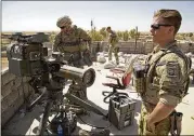  ?? BALINT SZLANKO / AP ?? U.S. soldiers stand next to a missile launcher in the Iraqi village of Abu Ghaddur, east of Tal Afar, on Sunday. Iraqi forces are trying to retake Tal Afar, one of the last pockets of IS-held territory in Iraq.