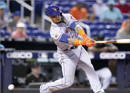  ?? LYNNE SLADKY — THE ASSOCIATED PRESS ?? New York Mets’ Javier Baez strikes out swinging during the first inning of a baseball game against the Miami Marlins, Thursday, Aug. 5, 2021, in Miami.