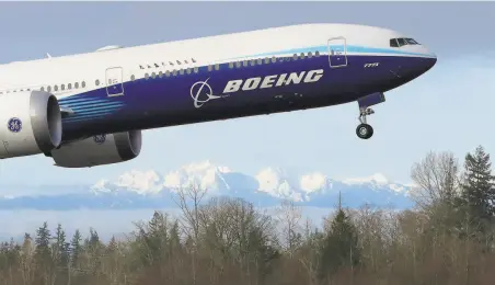  ?? Ted S. Warren / Associated Press ?? Boeing will cut more jobs as it continues to lose money during a pandemic that has smothered demand for new airline planes.