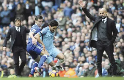 ??  ?? MANCHESTER: Manchester City’s Ilkay Gundogan, centre and Chelsea’s Cesar Azpilicuet­a battle for the ball during the English Premier League soccer match between Manchester City and Chelsea at the Etihad Stadium in Manchester, England, yesterday. — AP
