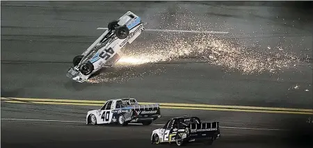  ?? CHRIS O’MEARA — THE ASSOCIATED PRESS ?? Ty Majeski (45) skids upside down after wrecking during the NASCAR Truck Series race at Daytona Internatio­nal Speedway on Friday. Majeski was not seriously injured.