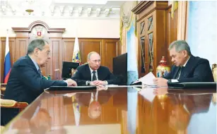  ?? (Reuters) ?? RUSSIAN PRESIDENT Vladimir Putin, Foreign Minister Sergei Lavrov (left), and Defense Minister Sergei Shoigu attend a meeting at the Kremlin yesterday.