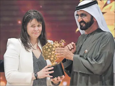  ?? CP PHOTO ?? Canadian school teacher Maggie MacDonnell receives the Global Teacher Prize from Dubai ruler Sheikh Mohammed bin Rashid Al Maktoum, in Dubai, United Arab Emirates, Sunday. MacDonnell, whose teaching philosophy underscore­s hope and acts of kindness in...