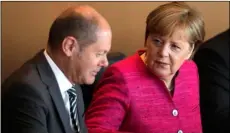  ?? AP Photo/MArkus schreIber ?? German Chancellor Angela Merkel (right)talks to Vice Chancellor and Finance Minister Olaf Scholz (left) prior to the weekly cabinet meeting of the German government at the chanceller­y in Berlin.