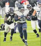  ?? Patrick Smith / Getty Images ?? Tennessee’s Derrick Henry scores the gamewinnin­g touchdown in overtime against Baltimore on Sunday. Henry had 28 carries for 133 yards in the Ravens’ 30-24 win.