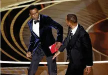  ?? MYUNG CHUN/LOS ANGELES TIMES/TNS ?? Chris Rock (left) and Will Smith onstage just after Smith slapped Rock during the 94th Academy Awards on March 27, 2022, in Hollywood, California.