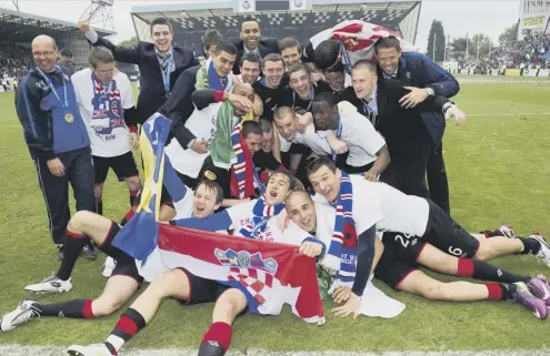  ??  ?? 0 Rangers players celebrate clinching the title by defeating Kilmarnock 5-1 at Rugby Park on the final day of the 2010-11 season.