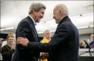  ?? ANDREW HARNIK— ASSOCIATED PRESS ?? In this Feb. 1, 2020, file photo Democratic presidenti­al candidate former Vice President Joe Biden smiles as former Secretary of State John Kerry, left, takes the podium to speak at a campaign stop at the South Slope Community Center in North Liberty, Iowa.