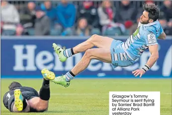  ??  ?? Glasgow’s Tommy Seymour is sent flying by Sarries’ Brad Barritt at Allianz Park yesterday